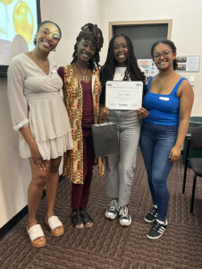 Sifa Lwesso (SON alumna '23, mentee) holding certificate of completion, pictured with the BNSAS leadership team 